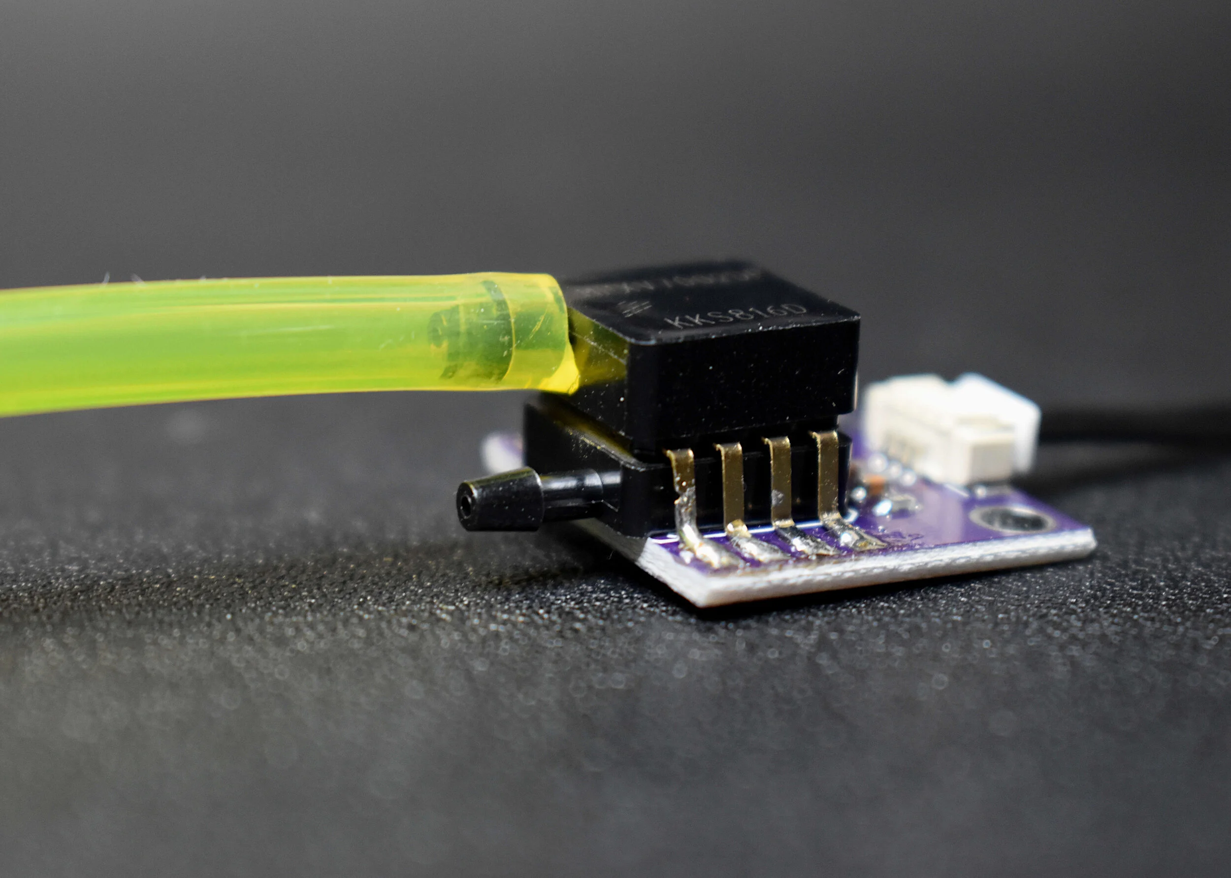 PVC Pitot tube connected to two hoses entering the differential pressure sensor